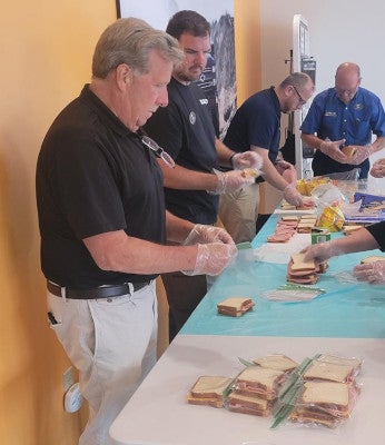 Man bagging sandwiches for fundraiser
